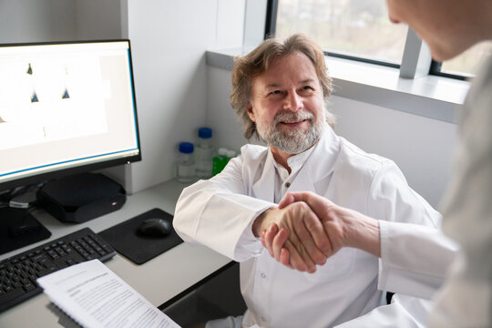 Scientists Shaking Hands in Lab