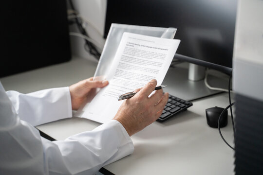 Person Reviewing Documents at a Desk in a lab