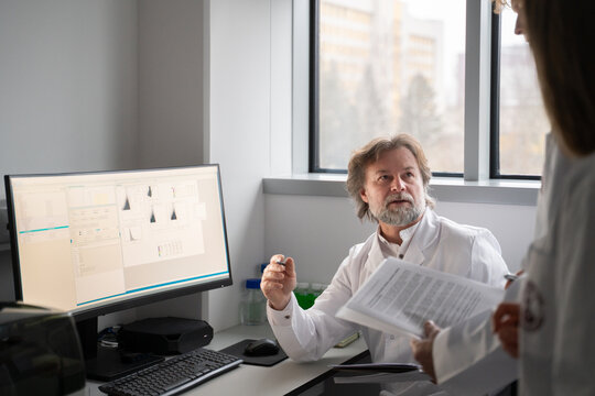 Scientists Discuss Research Findings in Lab
