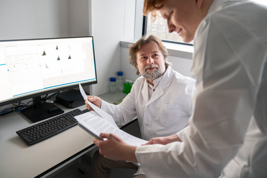 Student Discuss Research Findings With Professor in Lab