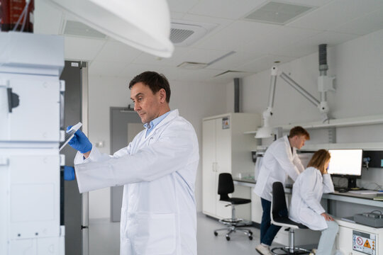 Scientists Work in a Lab on Various Experiments