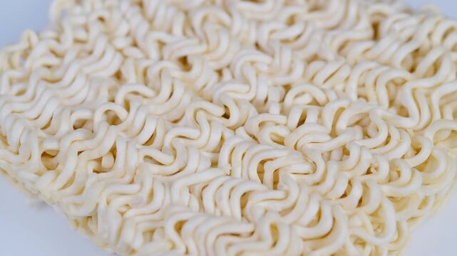 Uncooked noodle details. Highdetail shot emphasizing texture and shapes of uncooked noodles. Studio macro capturing intricate patterns and surface features of raw instant noodles