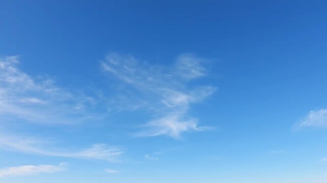 High dynamic range cinematic sky footage wide open blue horizon with thin wispy cirrus clouds and soft cumulus formations drifting slowly steady camera subtle motion natural daylight illumination ultr