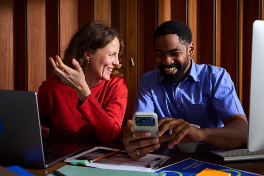 Colleagues sharing laughs at the office