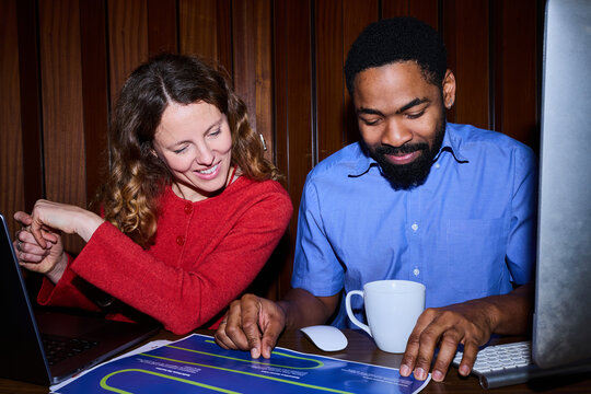 Colleagues work on a shared project