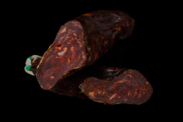 Artisan cured chorizo on black background