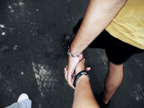 POV Couple Holding Hands While Walking Outdoors