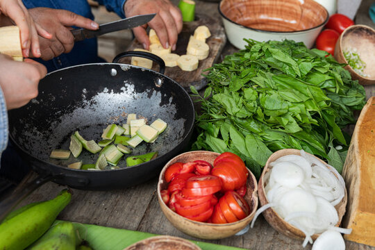 Various vegetables and greens on rustic table