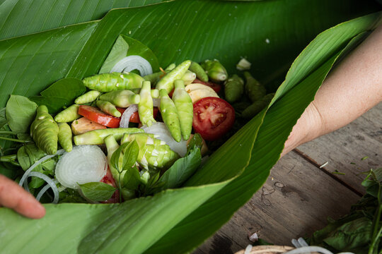 Wrapping Ingredients in Green Leaves for Steaming