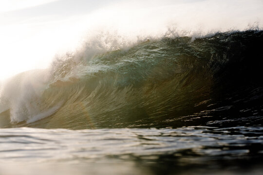 Panoramic view of a towering wave hitting the ocean