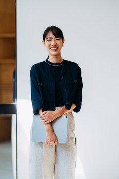 Businesswoman Holding Tablet in Modern Office