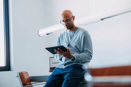 Businessman Using Tablet In Modern Office