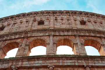 Fototapeta premium The Colosseum in Rome, an iconic symbol of the ancient Roman Empire, stands as a timeless monument to history, architecture, and human ingenuity.
