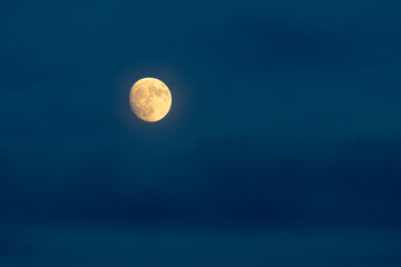 Night sky with a full moon and soft clouds. © Jan Haz