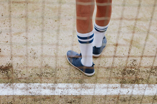 Kid's legs on outdoor sports court in focus