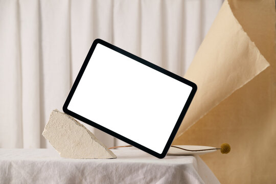 A modern tablet with a blank screen displayed on a table