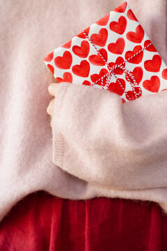 Woman holding present on Valentine's Day.