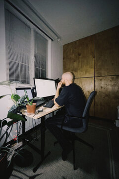 Man working late at home office at night