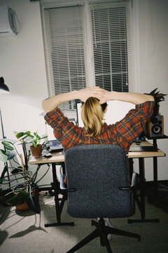 Woman stretching neck while working from home