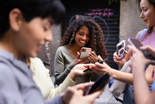 Group of friends enjoying social media on their smartphones