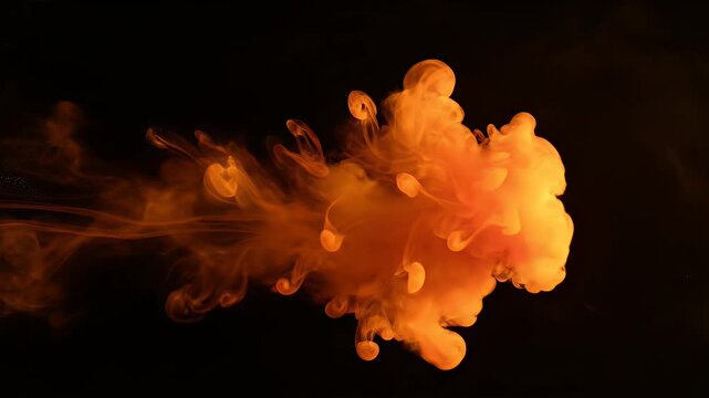 Abstract image of orange liquid expanding into a cloud shape against a black backdrop
