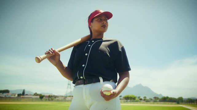 Confident woman ready to play baseball on the field