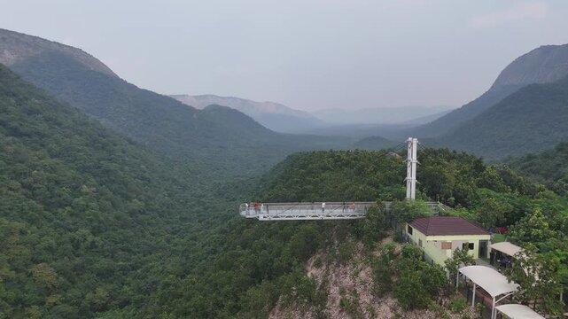 The Glass Bridge in Rajgir, Bihar, offers panoramic views of lush hills and valleys. Built with transparent tempered glass, it attracts tourists seeking adventure, scenic beauty, and elevated skywalk 