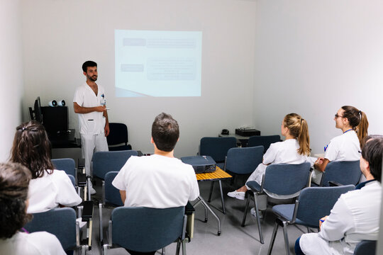 Medical professional giving presentation to healthcare workers