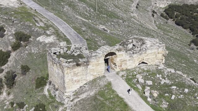 Cinematic aerial drone video footage of Blaundus Ancient City near Ulubey in Usak, Turkey, featuring ancient ruins, stone structures, and dramatic landscape from above in the Aegean region.