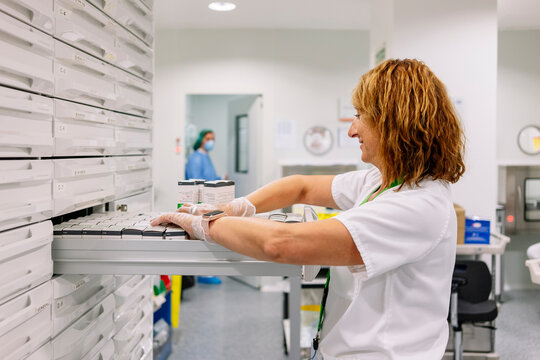 Pharmacist preparing medicine doses in hospital pharmacy department