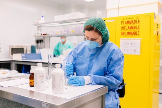 Researcher pharmacist compounding medicine in sterile