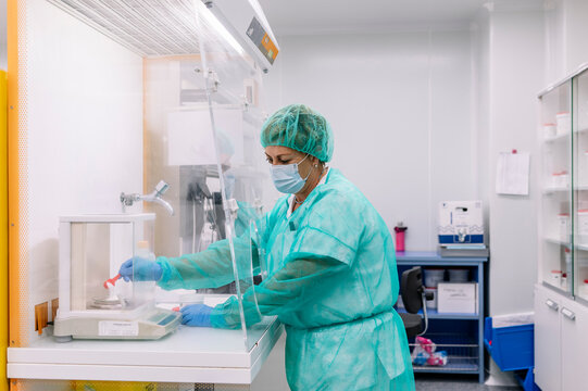 Pharmacist preparing medicine in hospital pharmacy laboratory