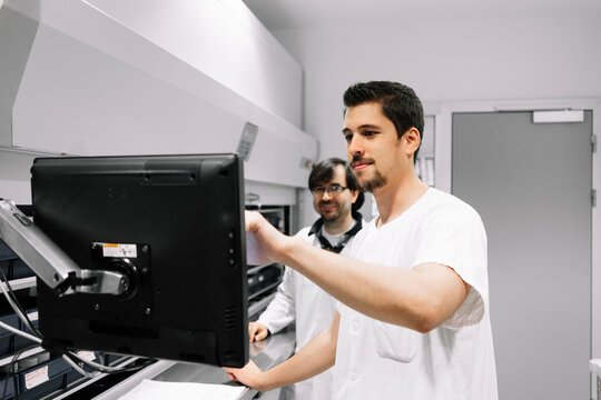 Pharmacist analyzing data on computer in hospital pharmacy