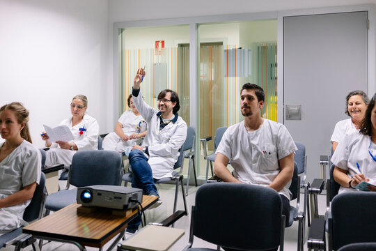 Medical professionals attending seminar and asking questions