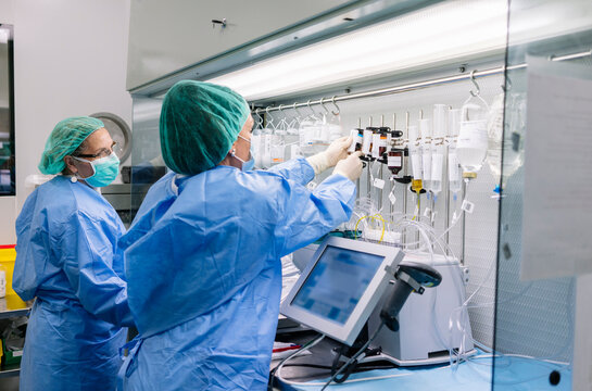 Pharmacists preparing intravenous medication in hospital pharmacy lab