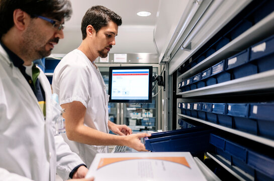 Pharmacists managing hospital pharmacy medicine inventory system