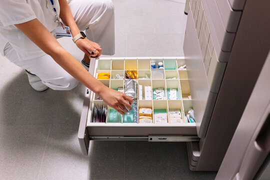 Healthcare professional selecting medicine from hospital
