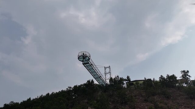 The Glass Bridge in Rajgir, Bihar, offers panoramic views of lush hills and valleys. Built with transparent tempered glass, it attracts tourists seeking adventure, scenic beauty, and elevated skywalk 