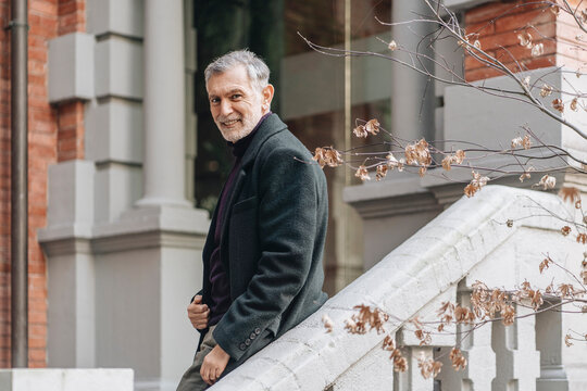 Senior man smiling arriving for business trip