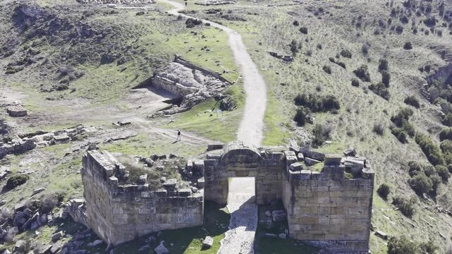 Cinematic aerial drone video footage of Blaundus Ancient City near Ulubey in Usak, Turkey, featuring ancient ruins, stone structures, and dramatic landscape from above in the Aegean region.