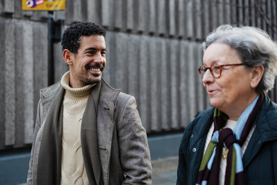 Man and older woman enjoying urban conversation
