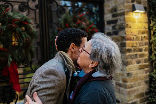 Mother and son embracing during Christmas homecoming