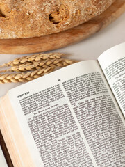 Bread, wheat, and holy bible book. Christian biblical concept of spiritual food and harvest.