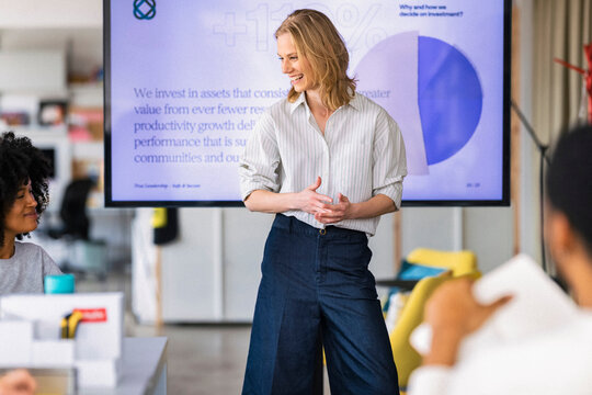 Confident Female Presenter Leads Office Meeting