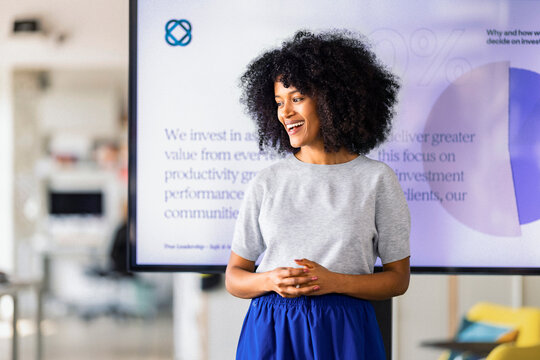 Confident Woman Presenter In Modern Office Setting