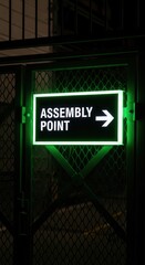 Obraz premium Illuminated Assembly Point Sign Guides Direction for Safety and Emergency Situations