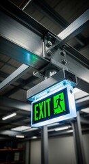 Illuminated Emergency Exit Sign Displaying Green Light in Industrial Building Interior Setting