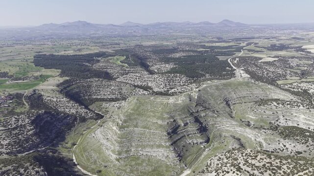 Cinematic aerial drone video footage of Blaundus Ancient City near Ulubey in Usak, Turkey, featuring ancient ruins, stone structures, and dramatic landscape from above in the Aegean region.