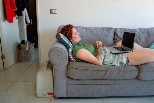 Woman Relaxing at Home With Laptop