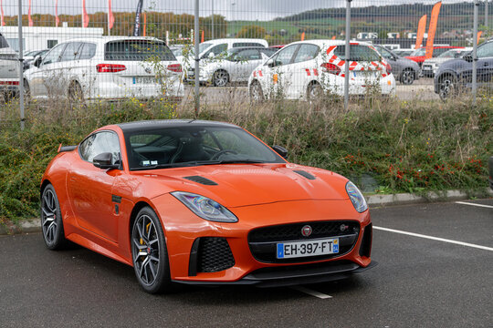 Nancy, France - October 26th 2025 : View on an orange Jaguar F-Type SVR parked on a street.
